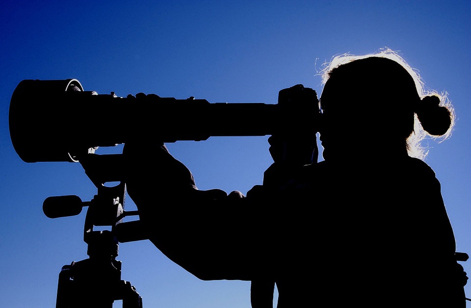 woman using telescope